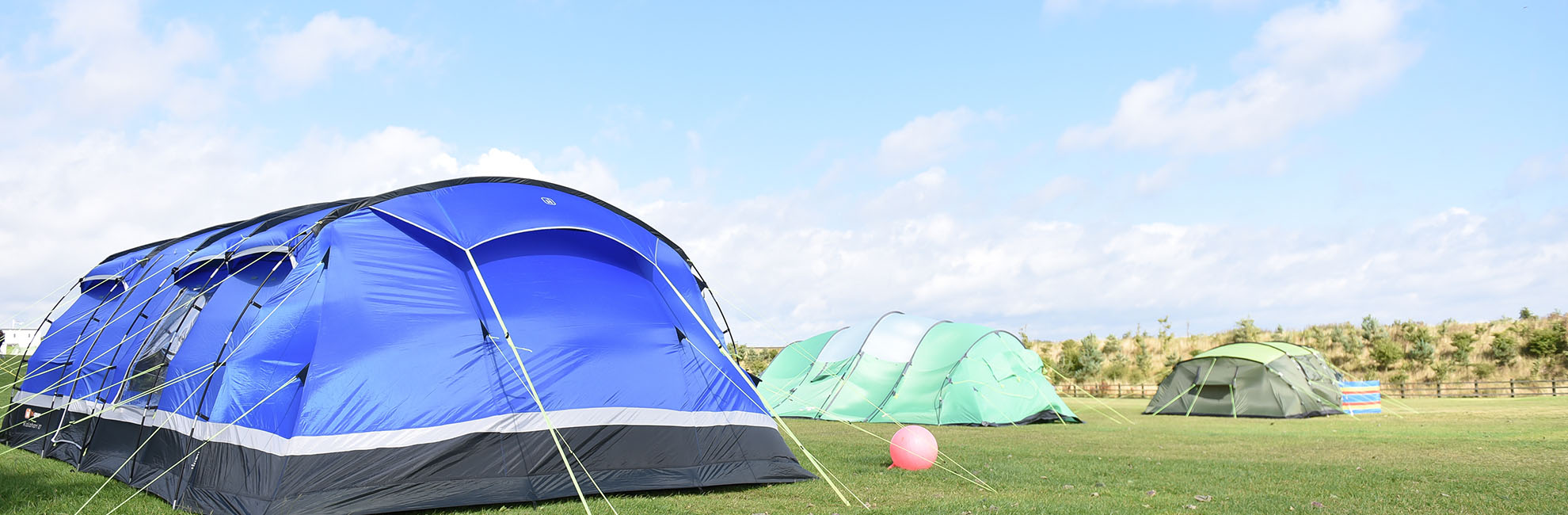 Tents pitched up on the grass