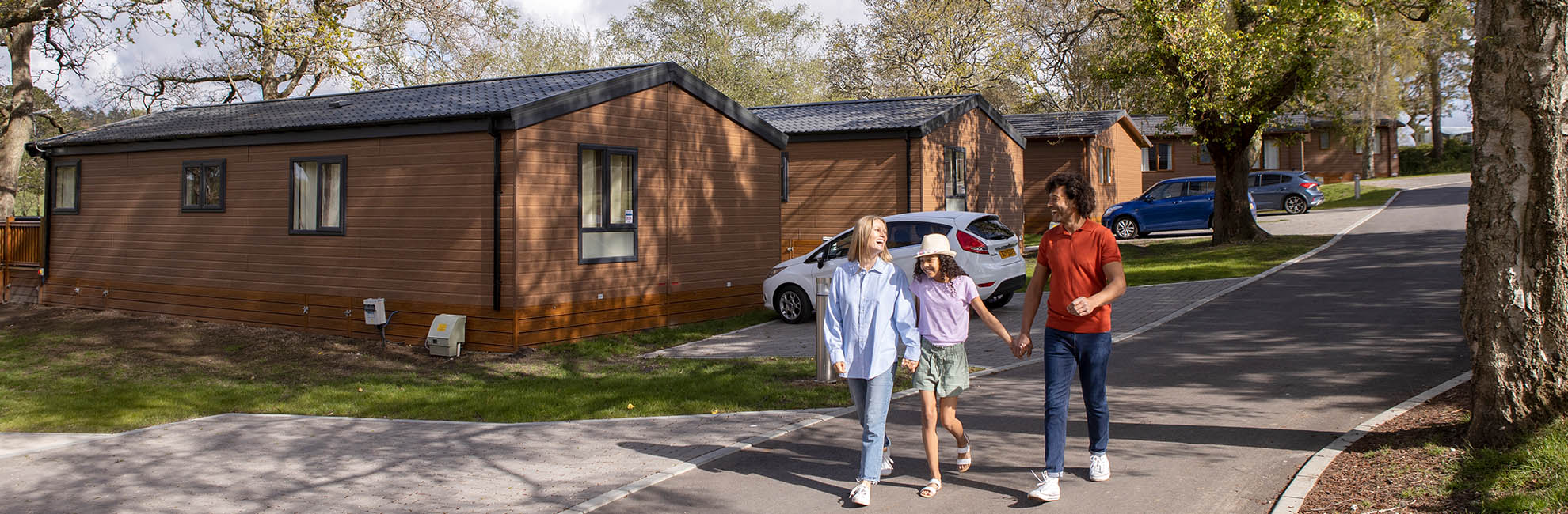 A family walking through the new lodge development at Sandford