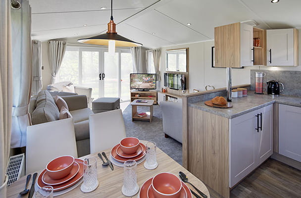 The open plan living room and kitchen diner of an extra wide caravan
