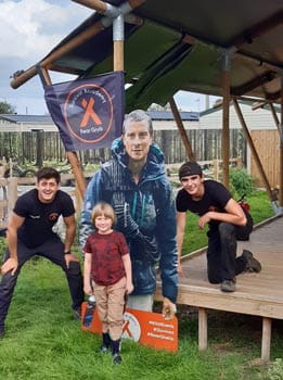 Young children stood with cardboard cutout of Bear Grylls 