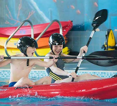 Kids kayaking in pool