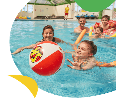 A family having fun with a beach ball in a swimming pool