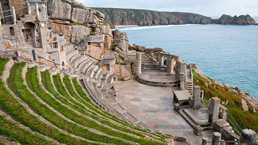 An open air theatre perched on top of a cliff overlooking the sea at the Minack Theatre in Cornwall