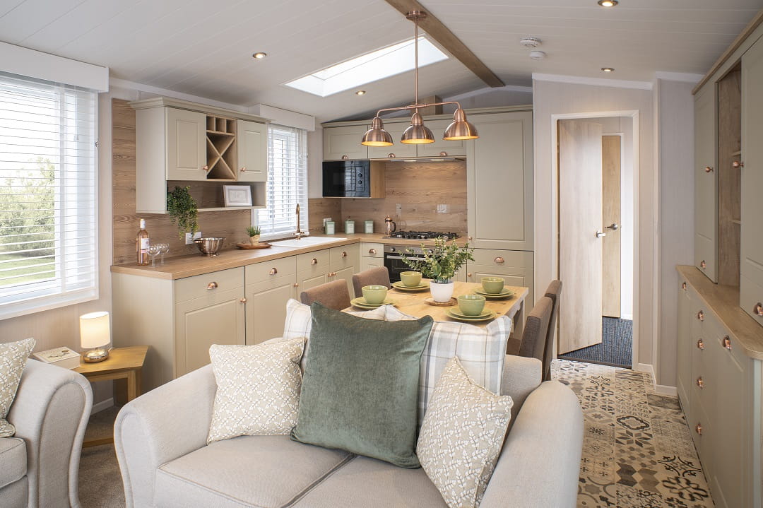 A spacious kitchen and lounge in a new caravan