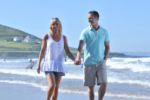 couple holding hands on a beach