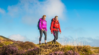two female walkers hiking in the countryside