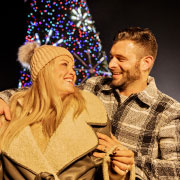 Couple in front of Christmas tree
