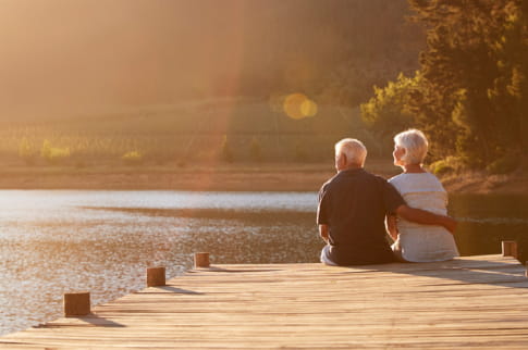 Elderly couple sat on the dock watching the world go by