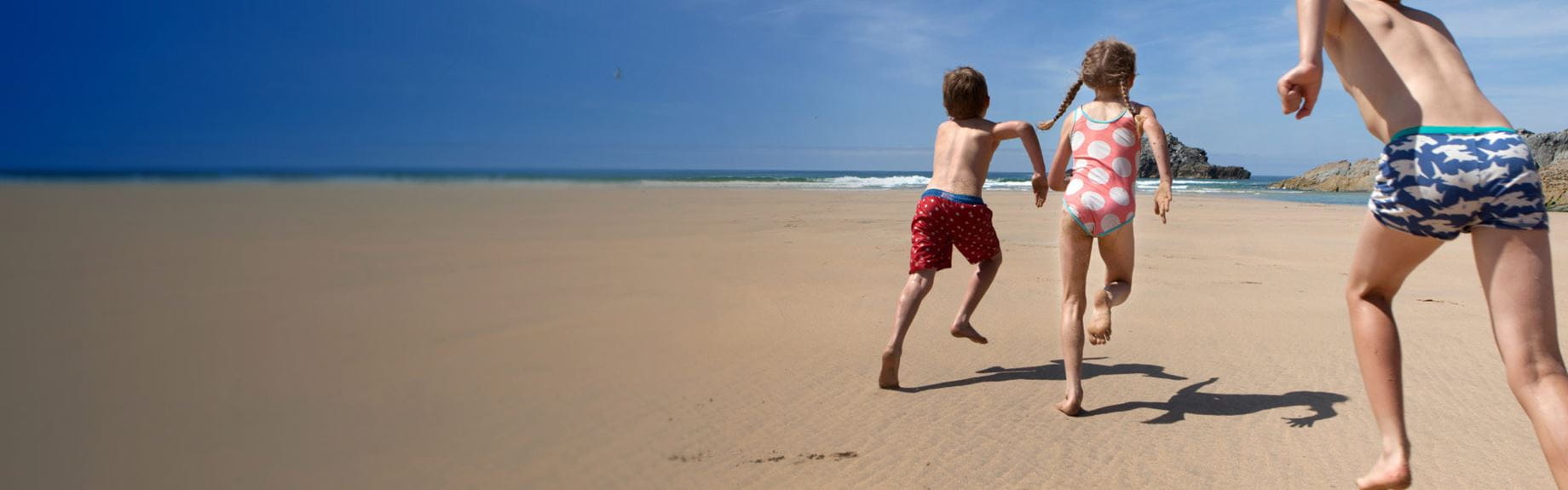 Kids running on beach
