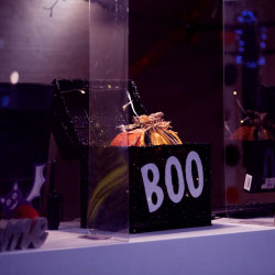 Black box with the word 'boo' written on it with a pumpkin inside