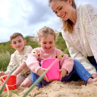 Little girl building a sandcastle