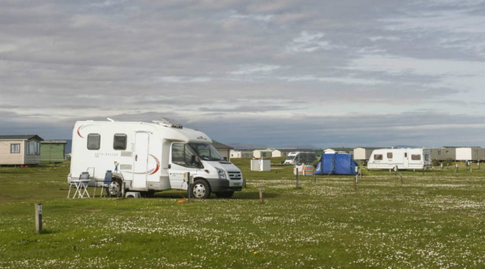 Motorhomes and touring caravans pitched up on the grass at Grannie's Heilan' Hame Holiday Park