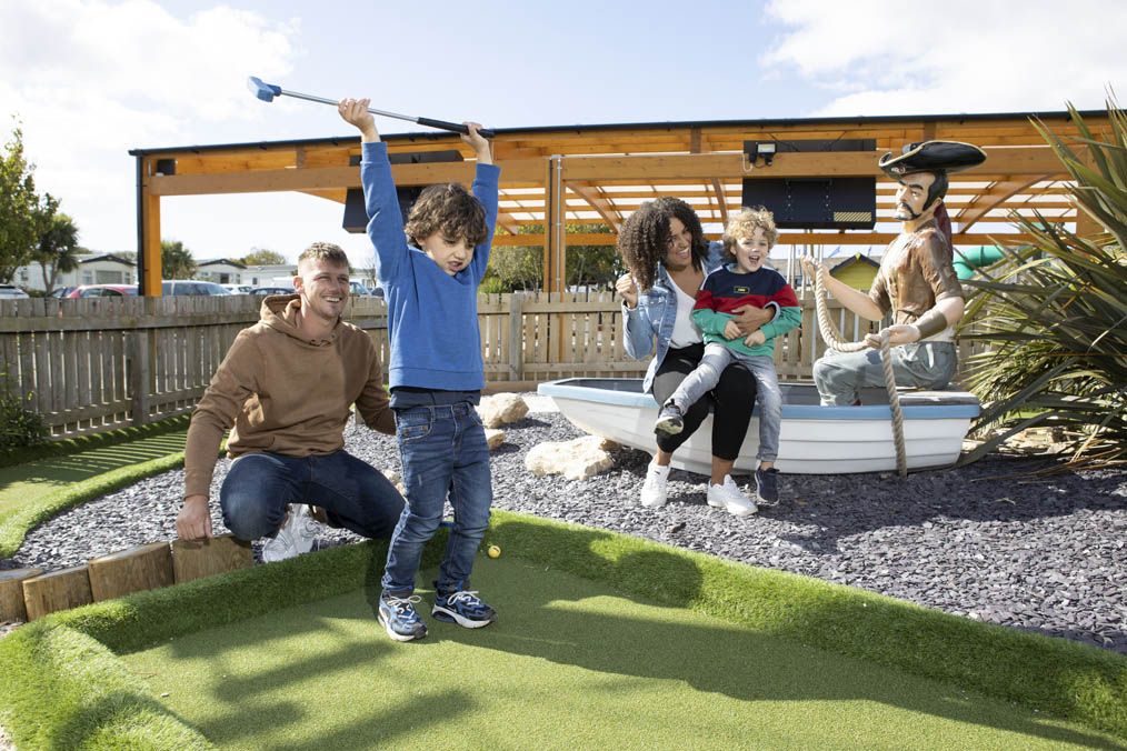 Family playing crazy golf together