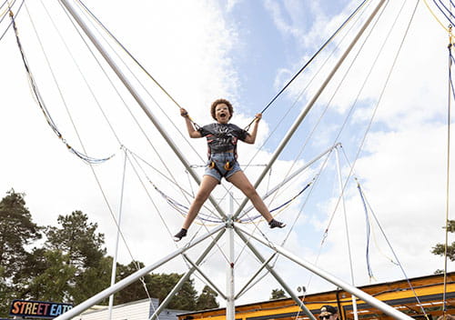 child jumping in the air on the bungee trampolines