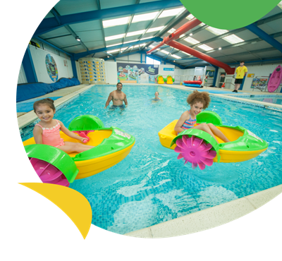 Kids on Aqua Paddlers in the indoor swimming pool at Sandylands Holiday Park