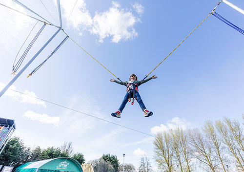 Child jumping in the air on the bungee trampolines