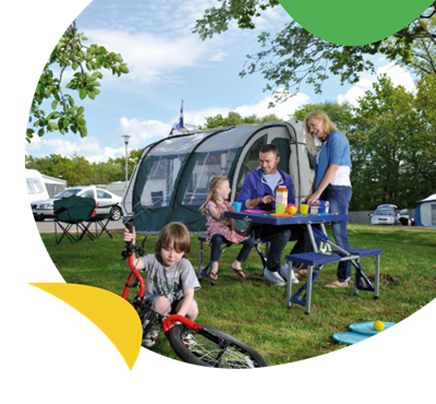A family relaxing around their tent at Sundrum Castle Holiday Park