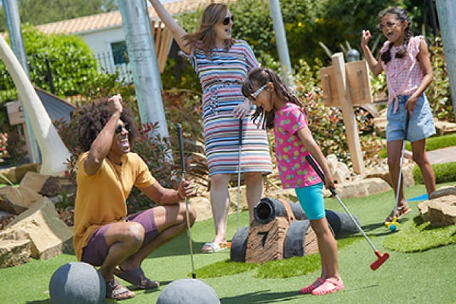 Family playing adventure golf 