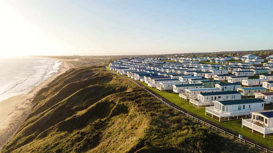 An aerial view of a caravan park overlooking the sea