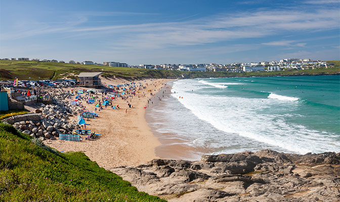 A busy summer day at Fistral Beach in Cornwall