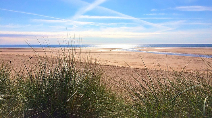 A view of expansive golden sands of Alnmouth beach