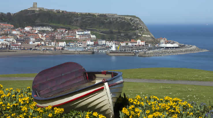 A rowing boat moored on the grass near Scarborough Harbour
